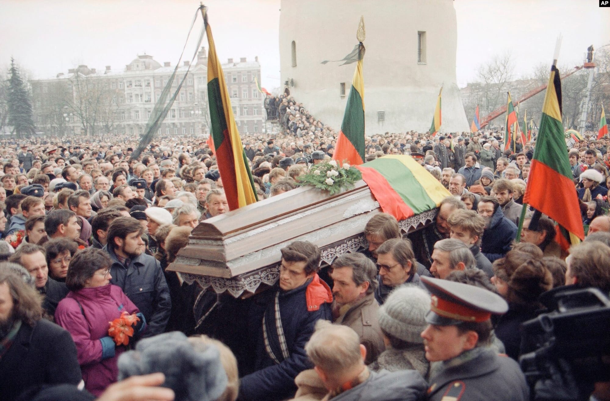 The coffin of one of the victims of the January Events in Vilnius in 1990 is carried through a large crowd gathered in the Cathedral Square for the funeral of the victims of the Soviet crackdown on Lithuania's claims to independence.